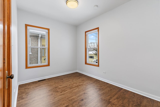 spare room featuring dark wood-type flooring