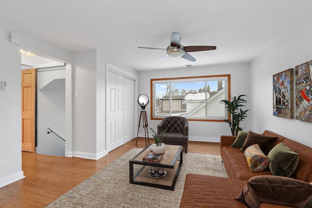 living room featuring ceiling fan and hardwood / wood-style floors