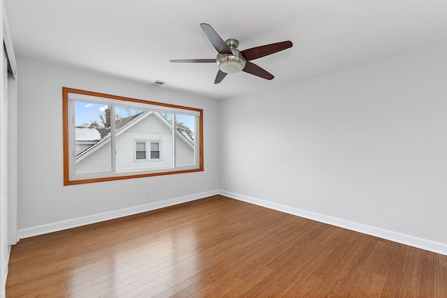 spare room with ceiling fan and wood-type flooring