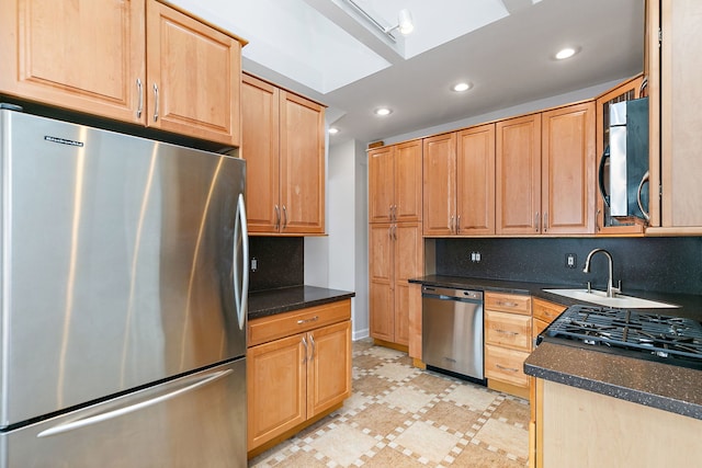 kitchen with backsplash, sink, and appliances with stainless steel finishes