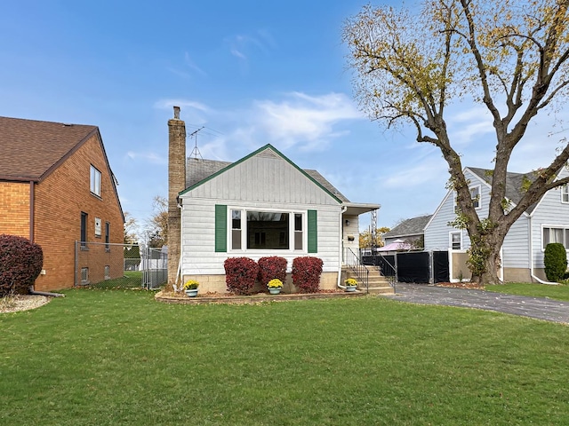 back of property with a lawn