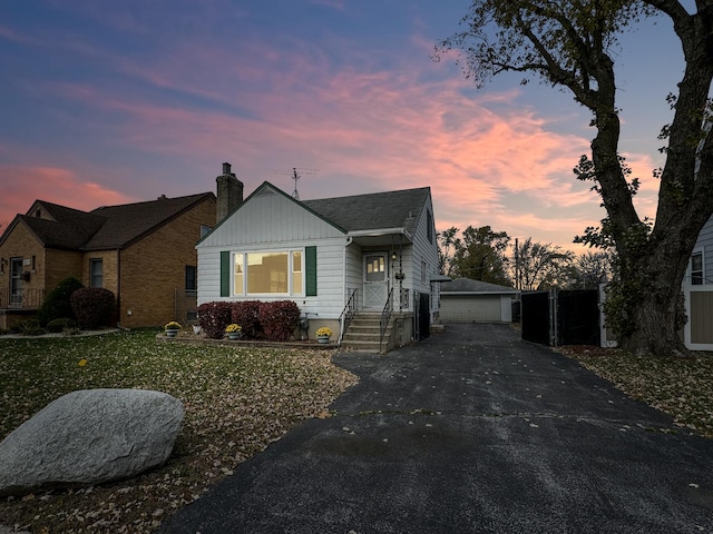 view of front of house featuring a garage and an outdoor structure