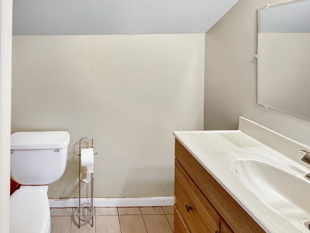 bathroom with tile patterned flooring, vanity, and toilet