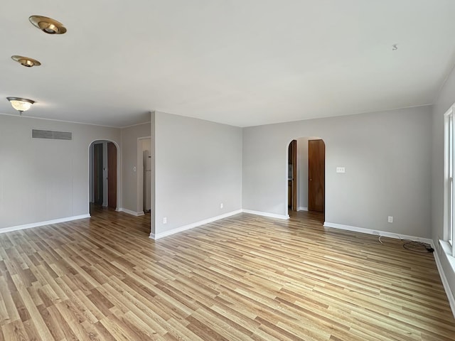 spare room with light hardwood / wood-style floors