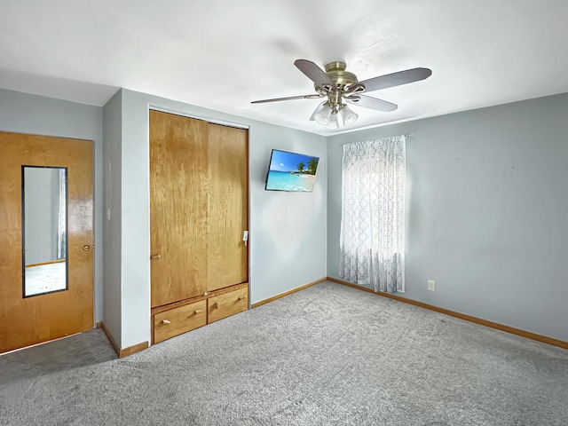 unfurnished bedroom featuring carpet, a closet, and ceiling fan