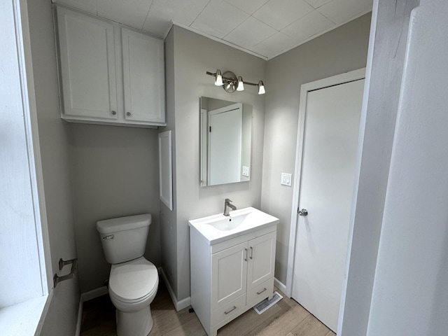 bathroom featuring hardwood / wood-style floors, vanity, and toilet