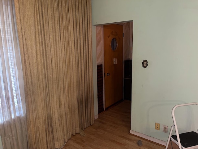 hallway with wood-type flooring