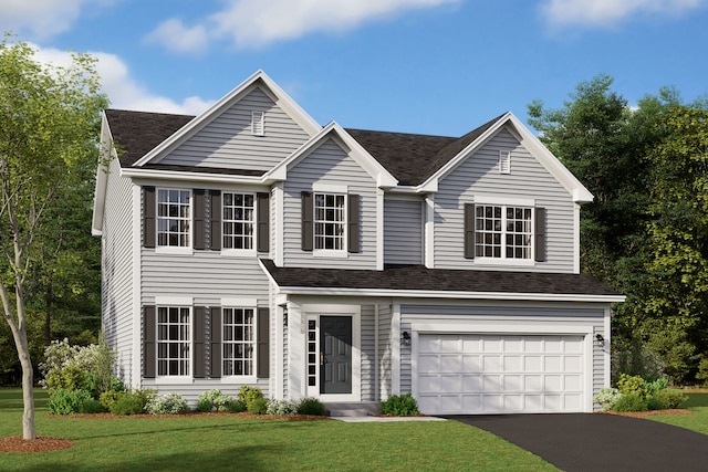 view of front of home with a front lawn and a garage