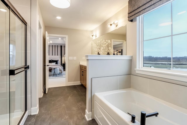 bathroom with vanity, separate shower and tub, and a water view