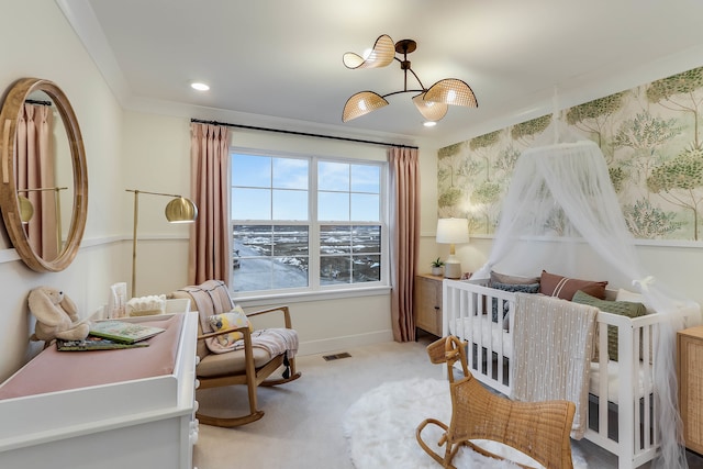 carpeted bedroom featuring a crib and ornamental molding