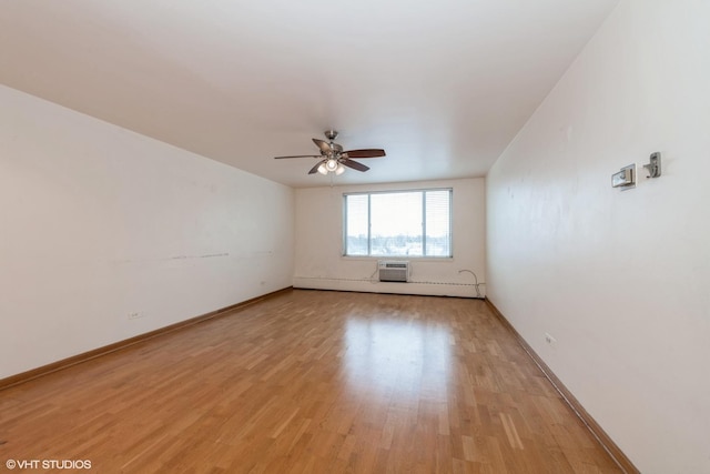 unfurnished room featuring ceiling fan, light wood-type flooring, and a wall mounted AC