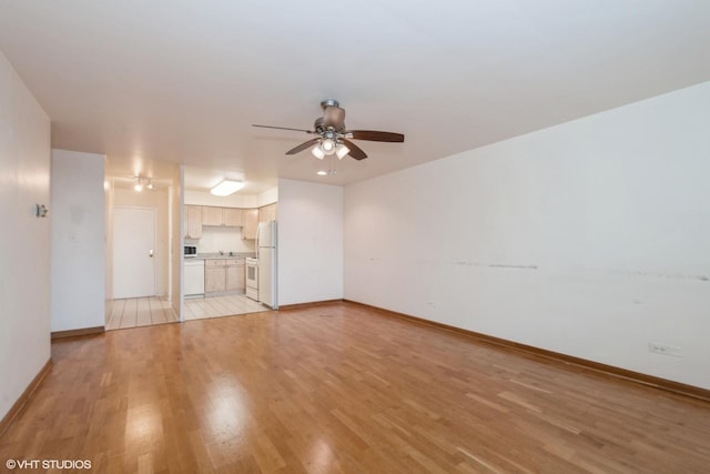 unfurnished living room featuring ceiling fan and light wood-type flooring