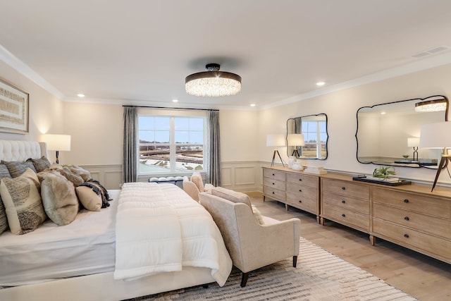 bedroom featuring light wood-type flooring and crown molding