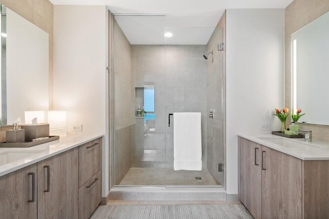 bathroom featuring tile patterned flooring, vanity, and a shower with door