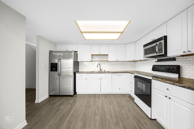 kitchen featuring white cabinets, sink, stainless steel appliances, and hardwood / wood-style floors