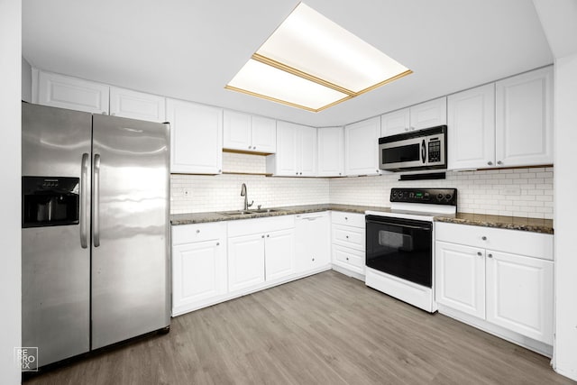 kitchen with white cabinets, sink, light wood-type flooring, and stainless steel appliances