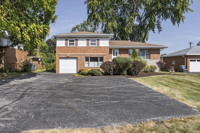 tri-level home with a garage and a front yard