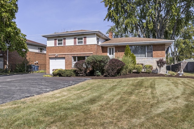 tri-level home featuring a garage and a front yard