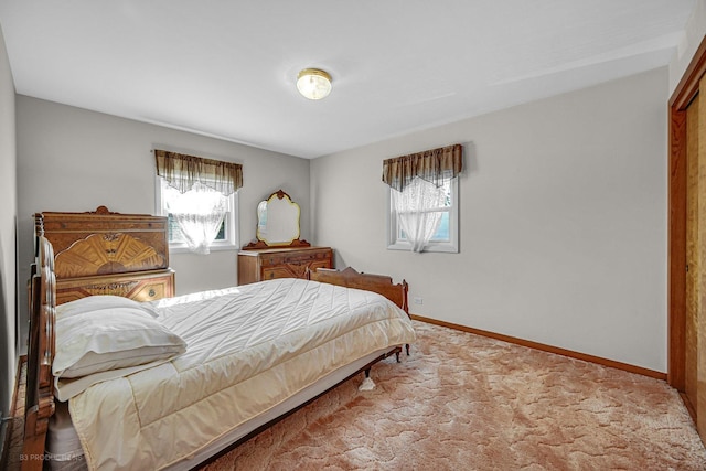 carpeted bedroom featuring multiple windows