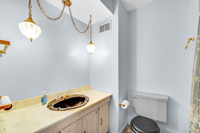 bathroom featuring vanity and toilet