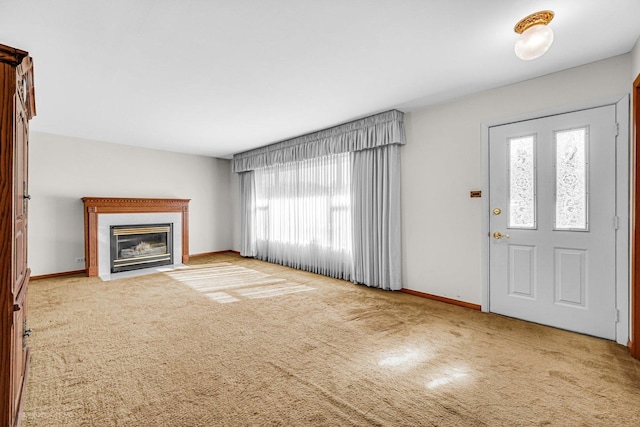 unfurnished living room with plenty of natural light and carpet flooring