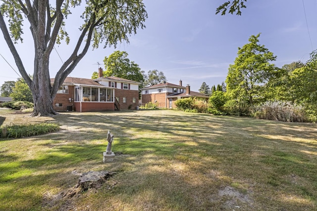 view of yard featuring a sunroom