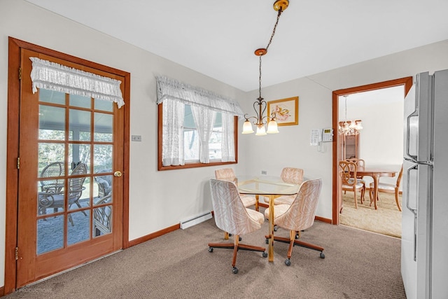 dining space with a baseboard radiator, carpet flooring, a notable chandelier, and a healthy amount of sunlight