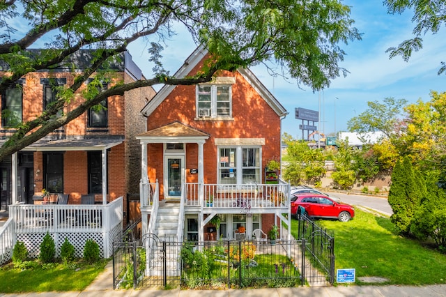 view of front of property with covered porch and a front lawn