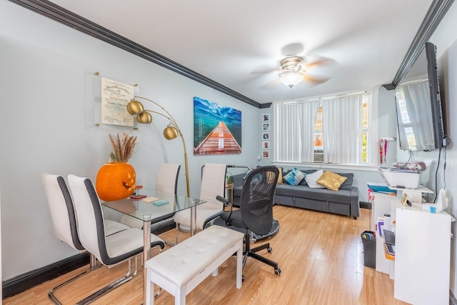 home office featuring ceiling fan, crown molding, and light wood-type flooring