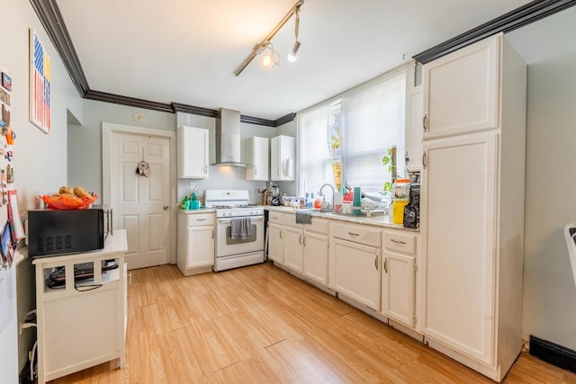 kitchen featuring white cabinets, wall chimney exhaust hood, light wood-type flooring, and white range with gas cooktop