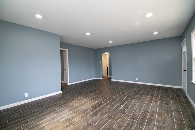 unfurnished room with dark hardwood / wood-style flooring