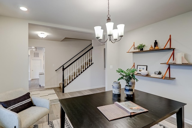 dining room featuring light hardwood / wood-style floors and a chandelier