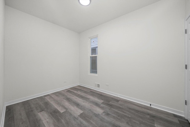 spare room with dark wood-type flooring