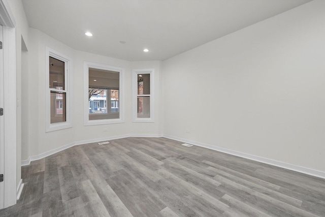 unfurnished room with light hardwood / wood-style floors