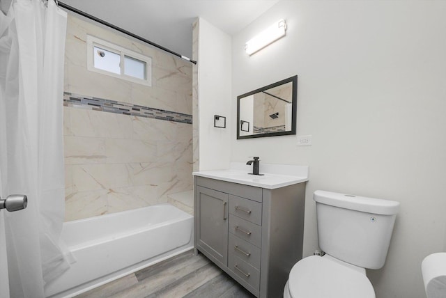 full bathroom featuring hardwood / wood-style floors, vanity, toilet, and shower / bathtub combination with curtain