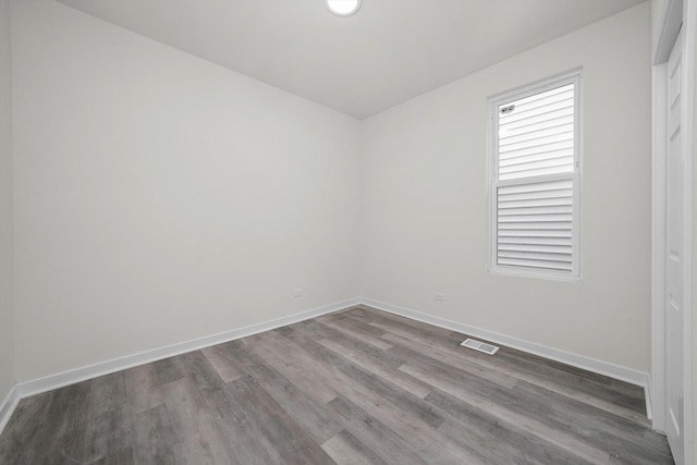 spare room with hardwood / wood-style floors