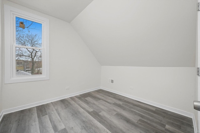 bonus room featuring hardwood / wood-style flooring and lofted ceiling