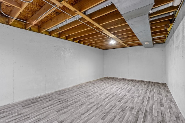 basement with hardwood / wood-style flooring