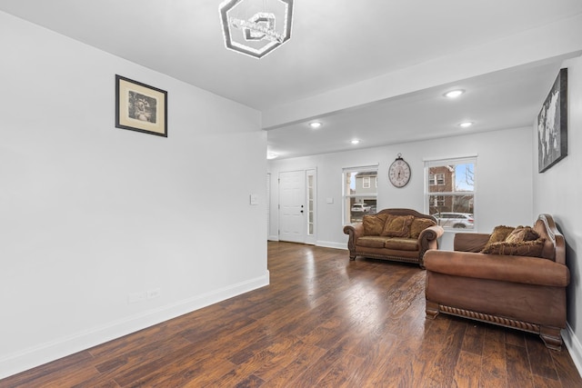 living room featuring dark hardwood / wood-style flooring and a notable chandelier