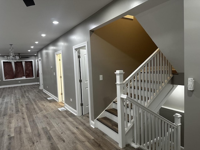 staircase with wood-type flooring