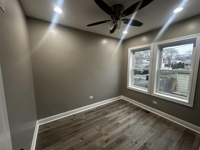 spare room with hardwood / wood-style floors and ceiling fan