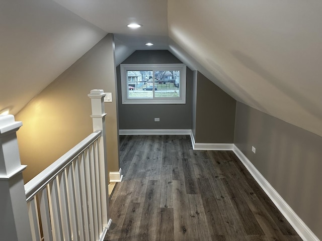 bonus room featuring vaulted ceiling and dark hardwood / wood-style floors