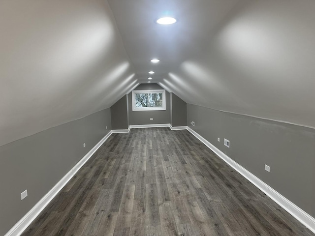 additional living space featuring dark hardwood / wood-style flooring and vaulted ceiling