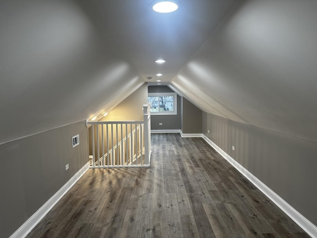 additional living space featuring dark hardwood / wood-style flooring and vaulted ceiling