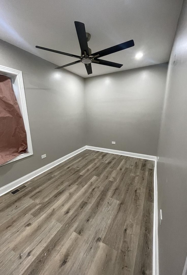 unfurnished room with hardwood / wood-style flooring and ceiling fan