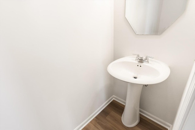 bathroom with baseboards and wood finished floors