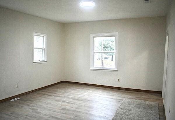 empty room with hardwood / wood-style flooring