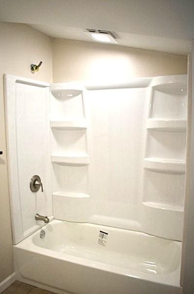 bathroom with tile patterned floors and shower / bathtub combination