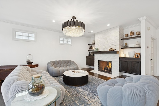 living area featuring a stone fireplace, a notable chandelier, recessed lighting, wood finished floors, and crown molding