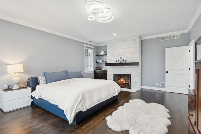 bedroom featuring a fireplace, baseboards, dark wood finished floors, and crown molding